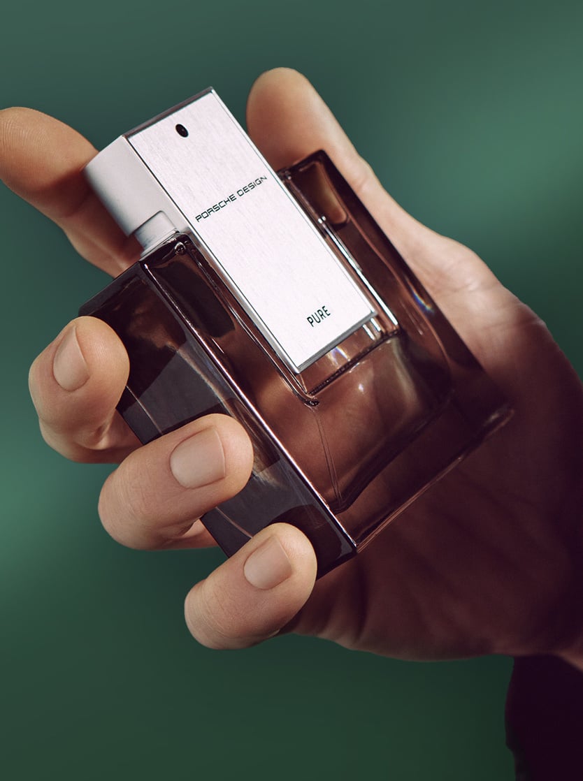 Hand holding a perfume from Prosche Design.